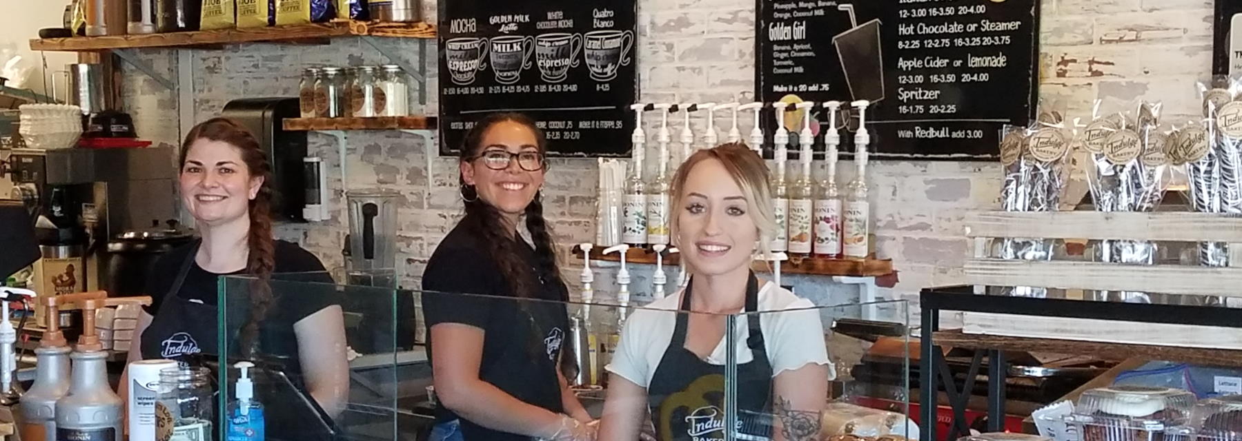 family of four kneeling behind van